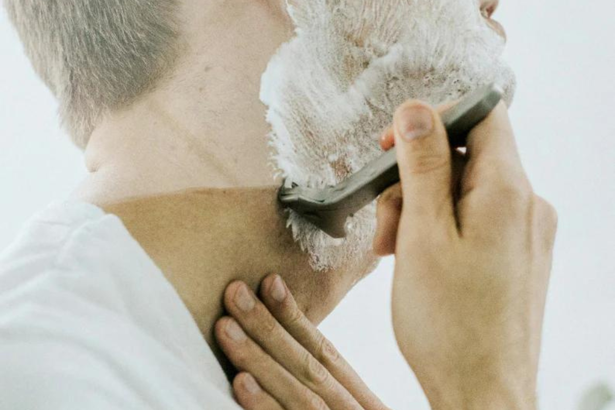 Achieve your smoothes shave. Man shaving with safety razor