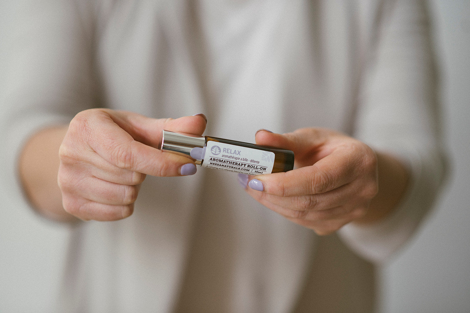 Woman applying Nezza Naturals all natural SPF lip balm to her lips 