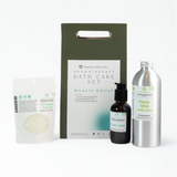 Nezza Naturals Bath Care Set featuring Muscle Relief Bubble Bath in aluminum, Bath Salts in compostable pouch and Muscle Relief Massage Oil in glass.